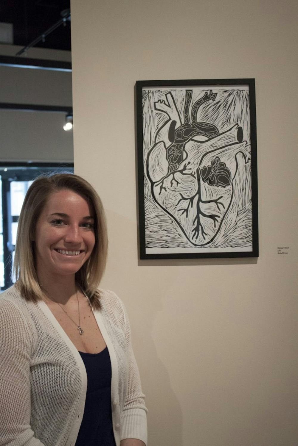	<p>Megan Bock with her work in the gallery.</p>