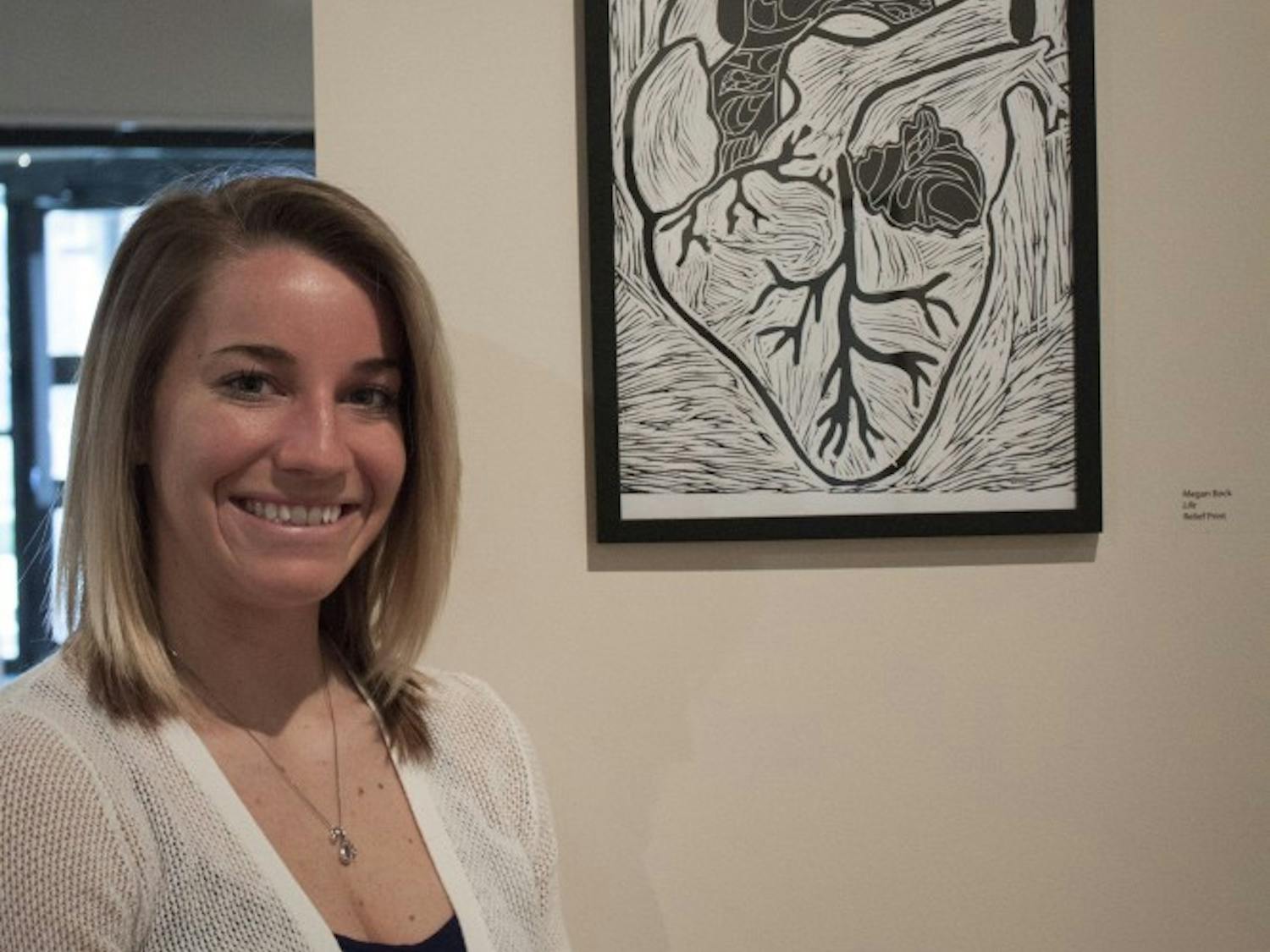 	Megan Bock with her work in the gallery.