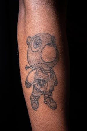 Arm tattoo of a bear from Kanye West's album Graduation.