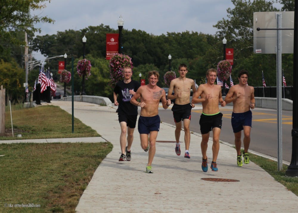 	Members of the Otterbein mens cross country team run through town, training for their next meet