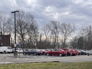 The commuter parking lot is extremely crowded due to limited parking availability.