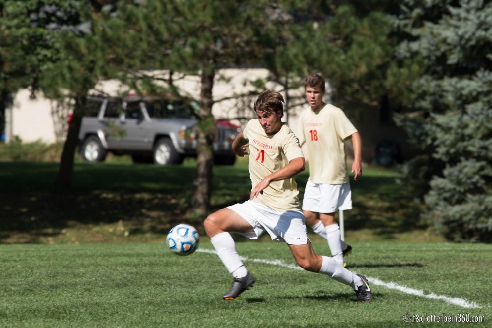 	Junior midfielder Conor Holland clears the ball from the Otterbein defense on a corner kick. 
