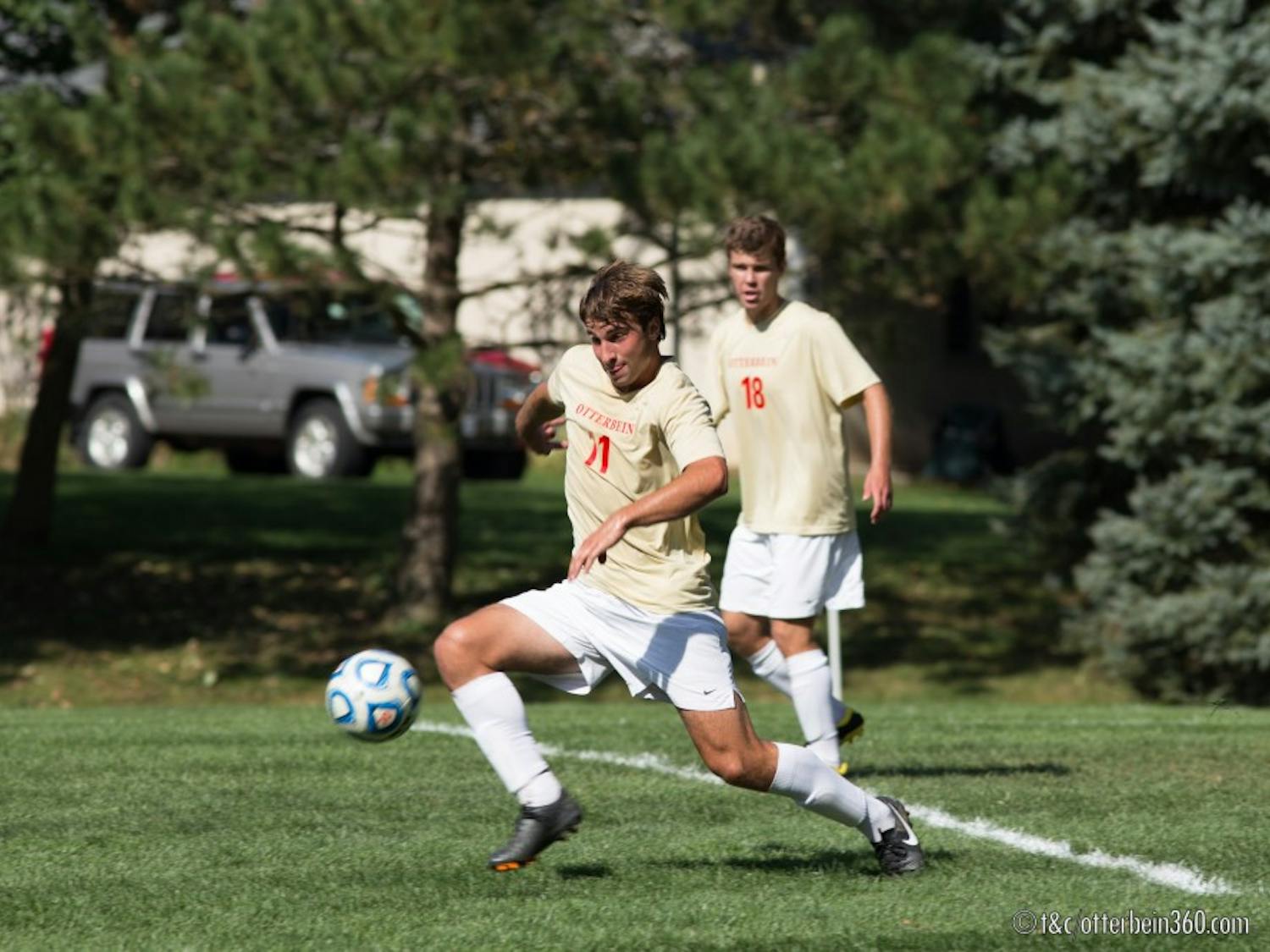 	Junior midfielder Conor Holland clears the ball from the Otterbein defense on a corner kick. 