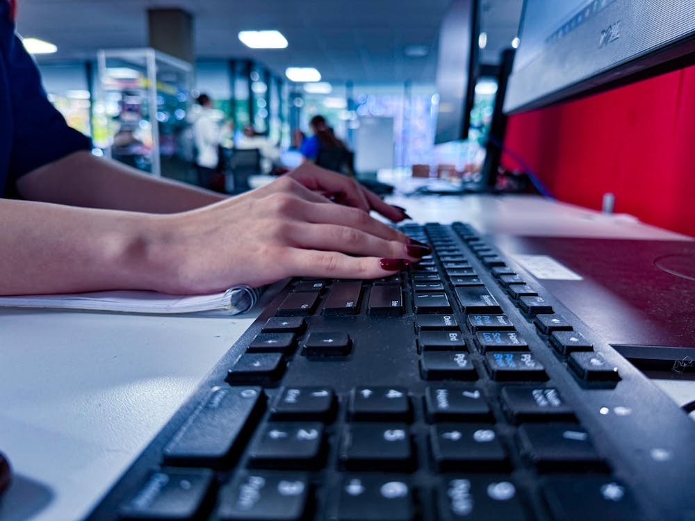 Zoe Florence, a sophomore psychology major, types at her computer in the Otterbein library.