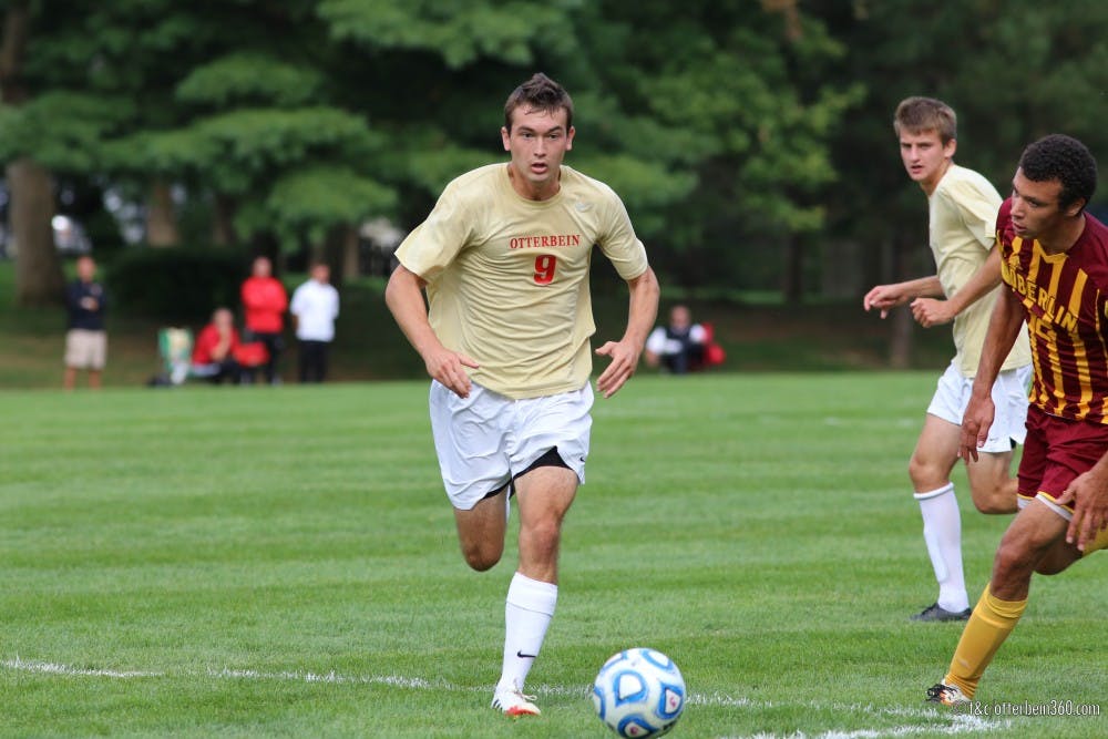 	<p>Pushing through the hardships endured in the game, junior Jared Pulliam dribbles into the defensive third. </p>