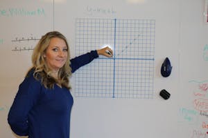 Sandy Light plots a graph in her math classroom