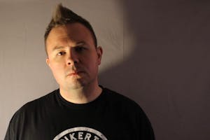 Headshot of a man in a black shirt. 