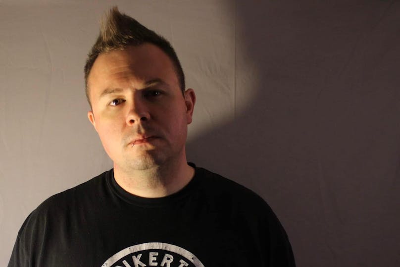 Headshot of a man in a black shirt. 