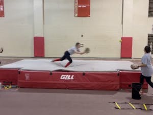 Softball Team Using Track and Field High Jump Mat at Practice