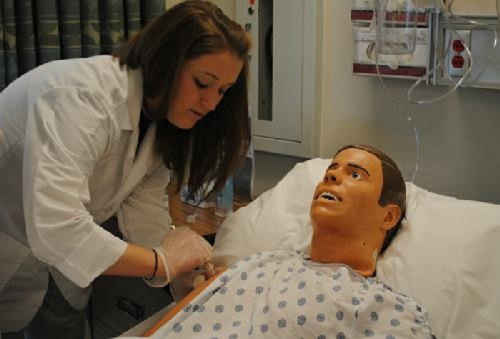 <p>In a file photo from 2011, an Otterbein nursing student works on a manikin.</p>