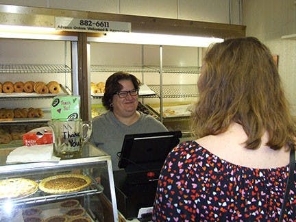 Schneider's employee helped a customer on the second day of accepting credit cards after 61 years of cash-only sales.