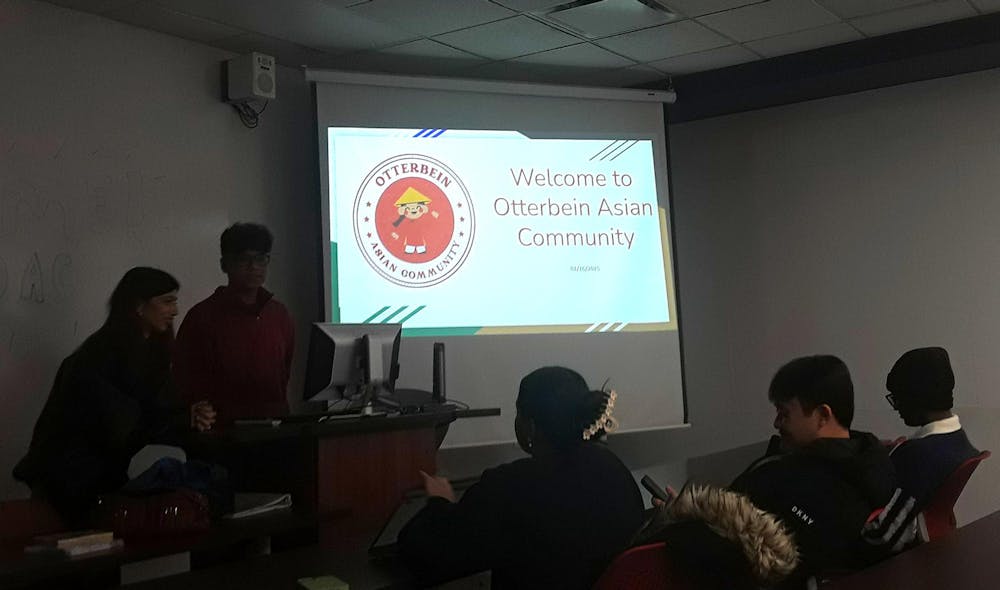 <p>Dylan Truong and Guari Subedi welcome members to the first meeting for the Otterbein Asian Community.</p>