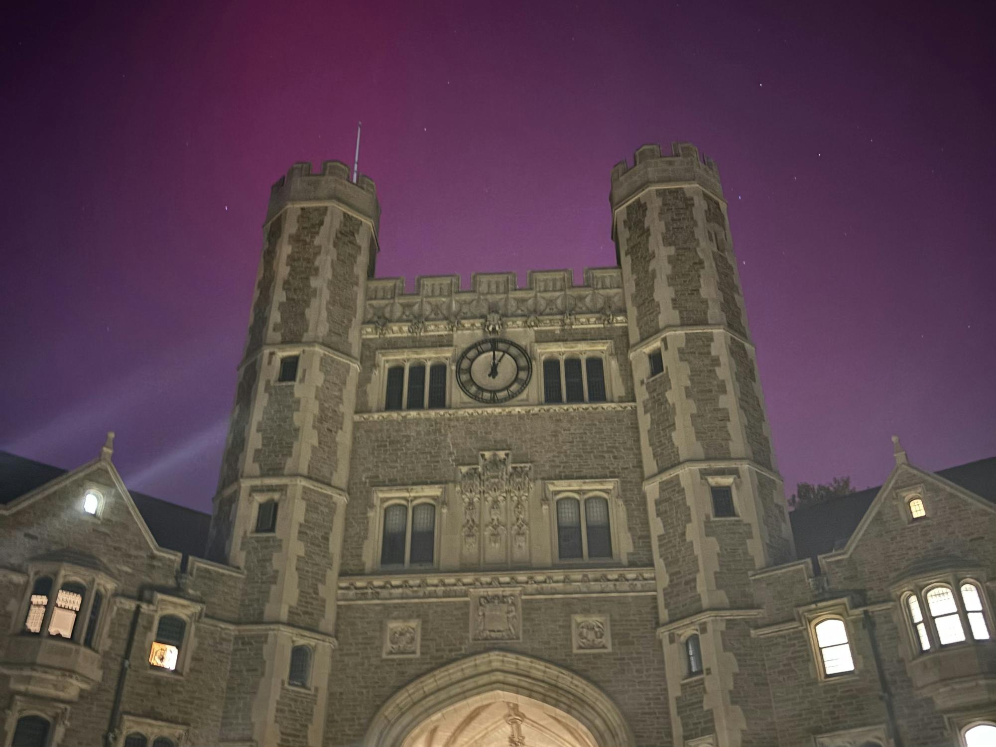 A pink and purple night sky above a gothic structure.