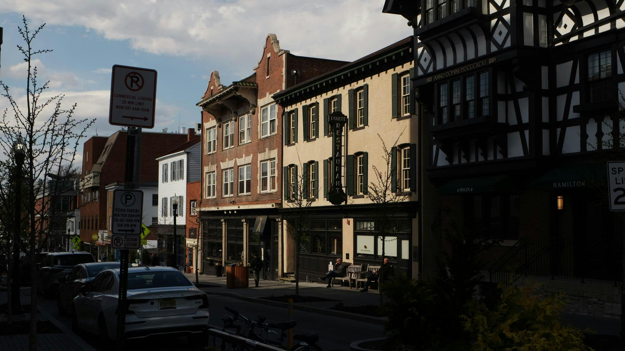 A dark street with a few buildings in the light