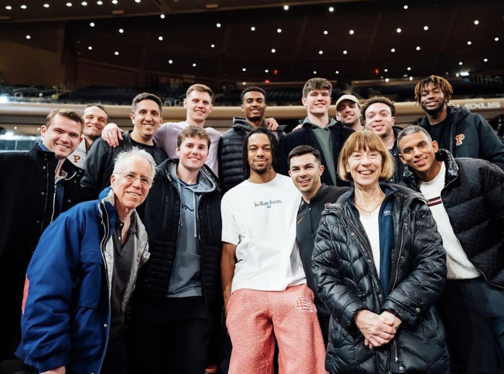 <h5>Tosan Evbuomwan ’23 posed with his former Princeton teammates and coaches as well as other members of the Princeton basketball family after his second ever NBA game in Madison Square Garden.</h5><h6>Photo courtesy <a href="https://www.instagram.com/p/C3DYPSvOuRF/?utm_source=ig_web_copy_link&amp;igsh=MzRlODBiNWFlZA==" rel="noopener noreferrer" target="_blank">@PrincetonMBB/X</a>.</h6>