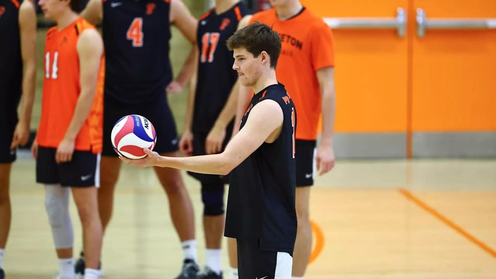 A player preparing to serve the volleyball.