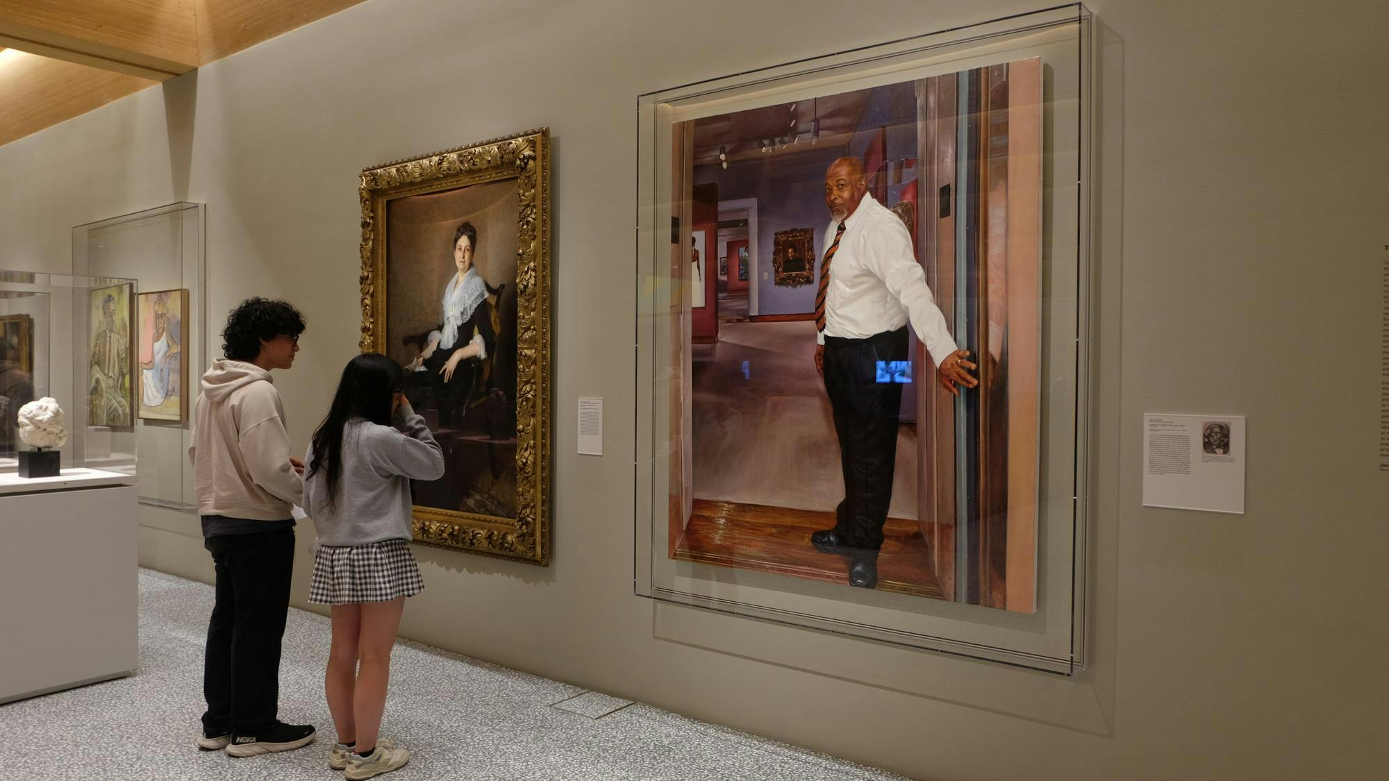 Students looking at portraits of Elizabeth Allan Marquand (Sargent, 1887) and Center of Creation (Michael) (Moore, 2019).JPG