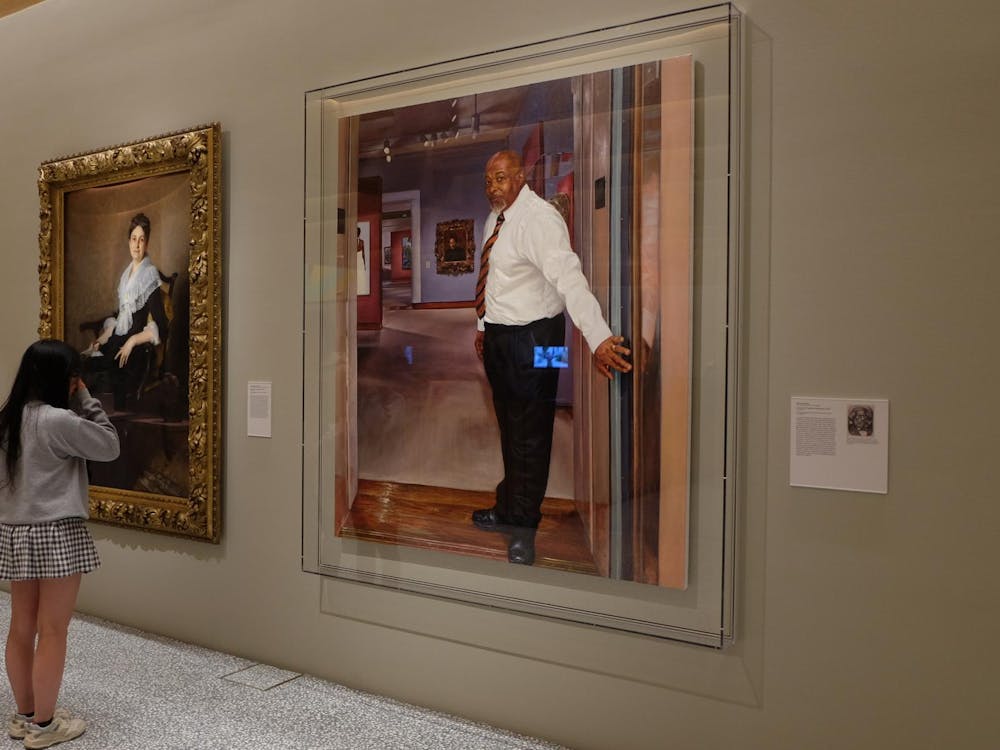 Students looking at portraits of Elizabeth Allan Marquand (Sargent, 1887) and Center of Creation (Michael) (Moore, 2019).JPG
