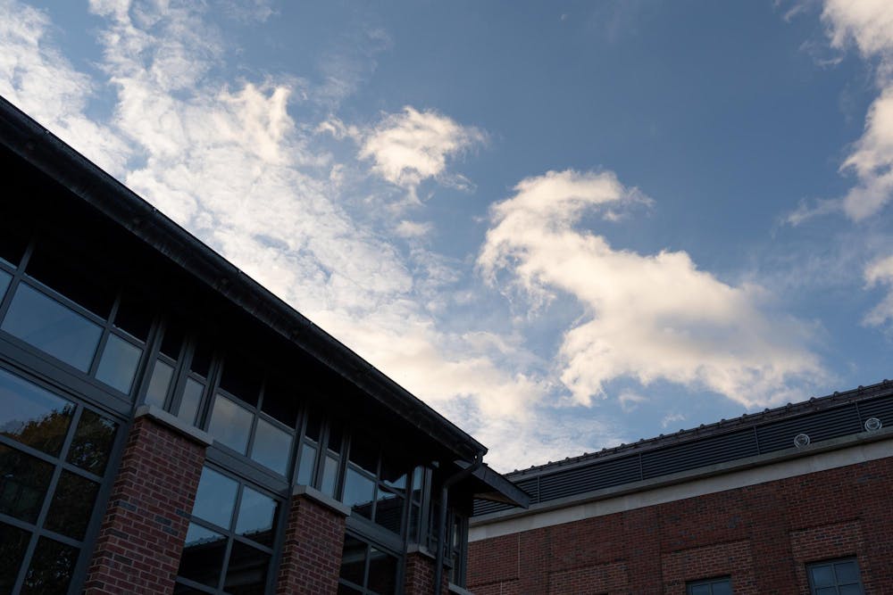 An angular building cuts against the blue sky.