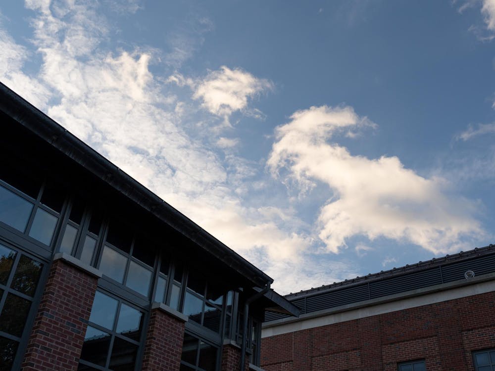 An angular building cuts against the blue sky.