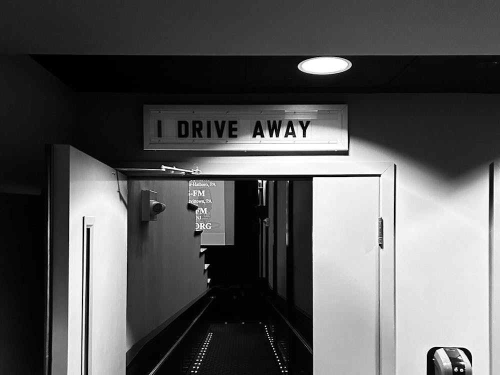 Theater entrance to "Drive Away Dolls" at the Garden Theatre. Text above the theater room reads "I drive away" in all caps. 