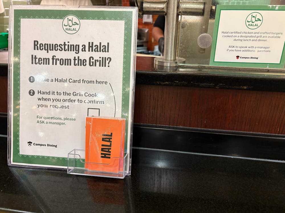 A plaque about instructions for students requesting a halal card at a dining hall. 