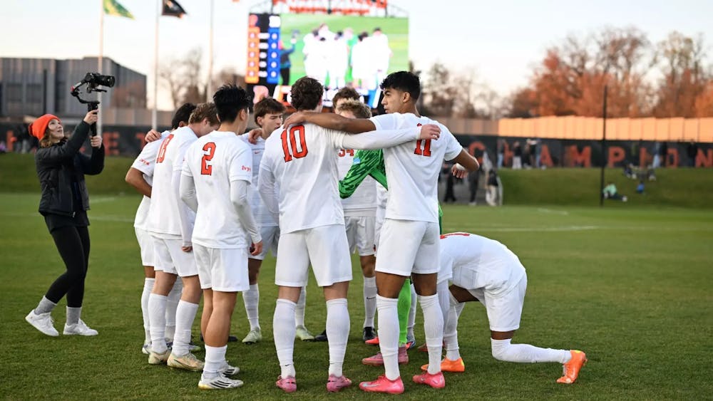 Players in white jerseys huddle up.