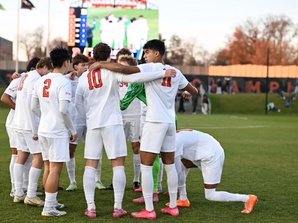 Players in white jerseys huddle up.