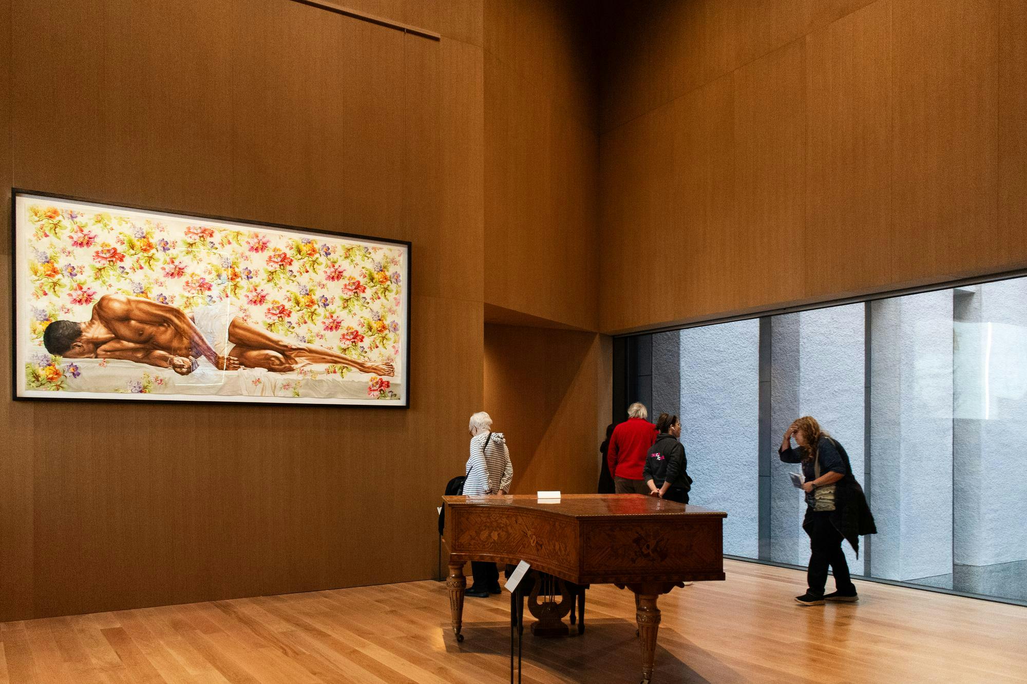 A piano in a wooden paneled room