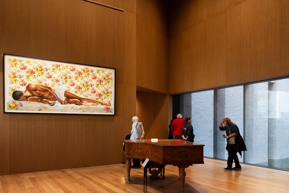 A piano in a wooden paneled room