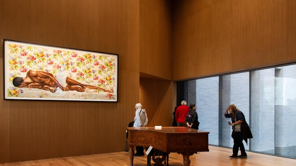 A piano in a wooden paneled room