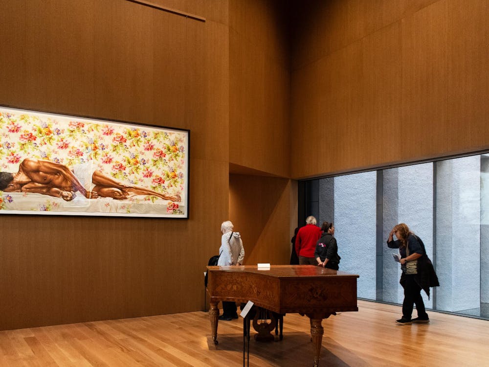 A piano in a wooden paneled room