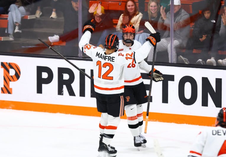 Two Princeton hockey players celebrating.