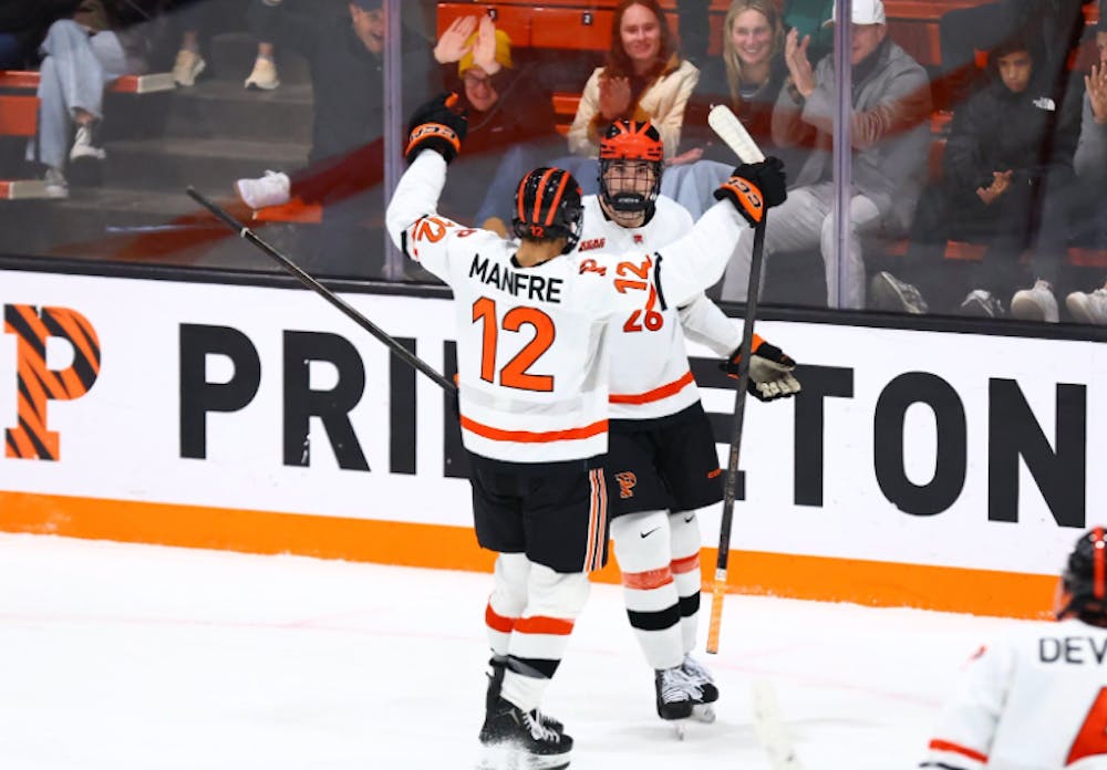 Two Princeton hockey players celebrating.
