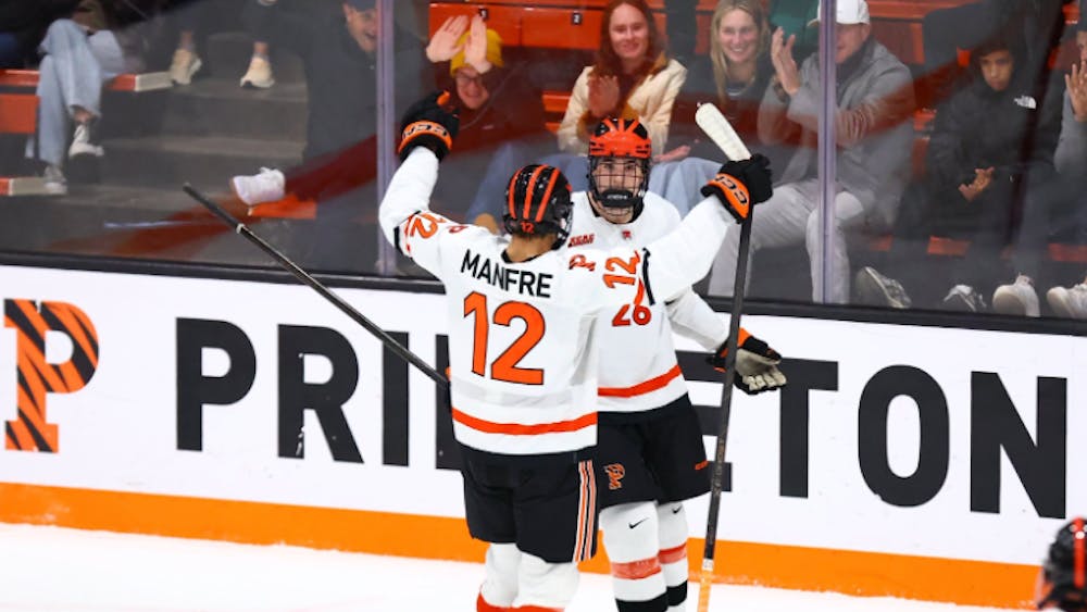 Two Princeton hockey players celebrating.
