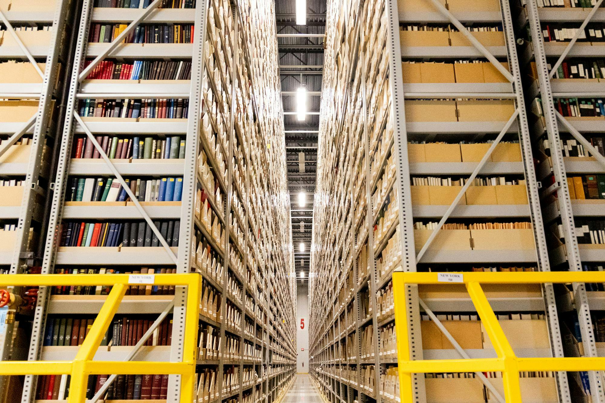 Stacks of books and other materials in a warehouse facility  