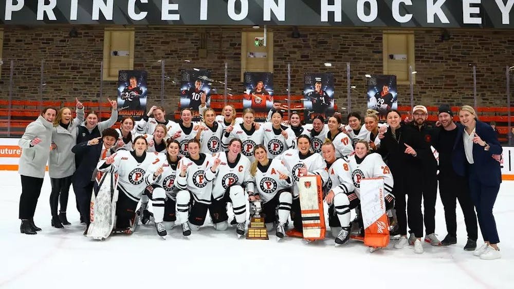 The Princeton women's hockey team celebrates on the ice.