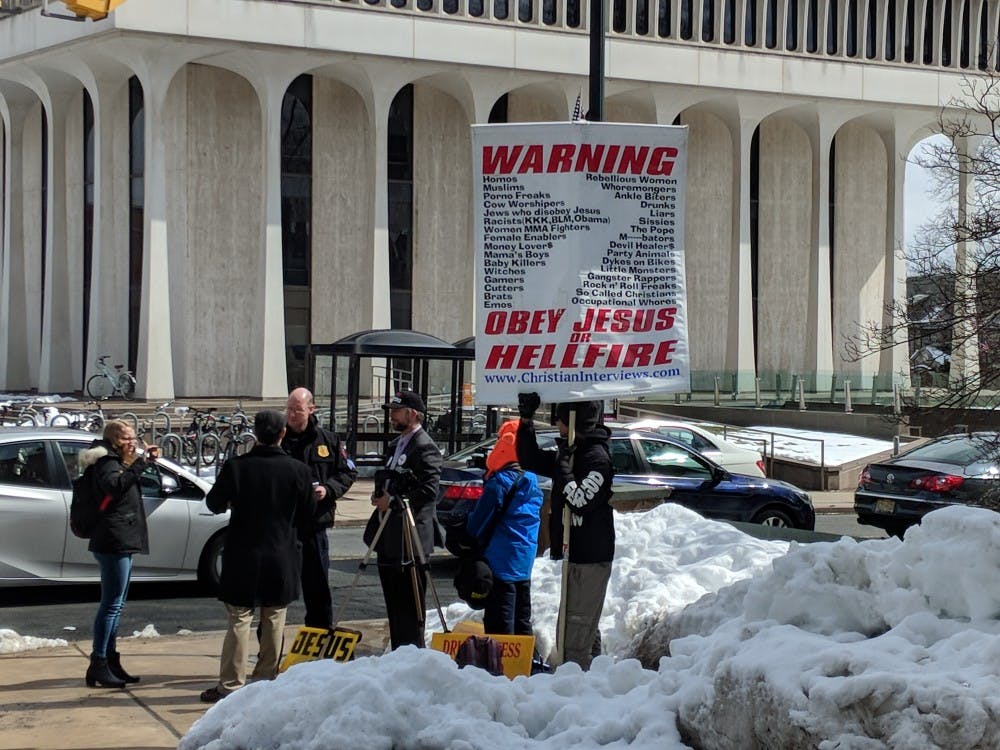 Public Safety officers confront protesters for upsetting students. 