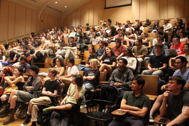 Rows of students gathered in an auditorium.