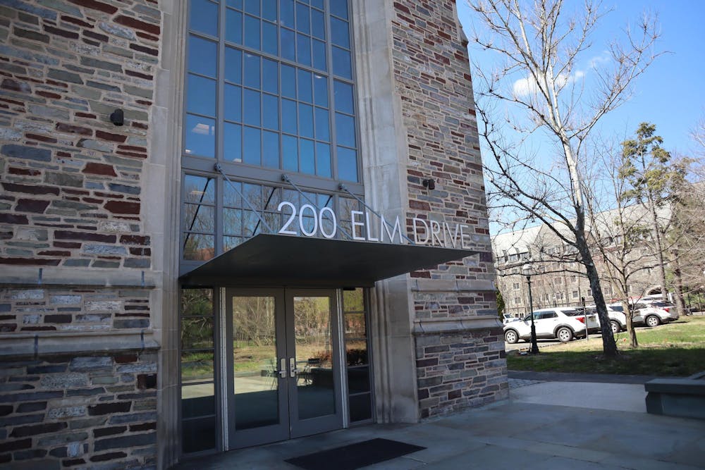 Brick building with large windows, addressed "200 Elm Drive" in silver lettering