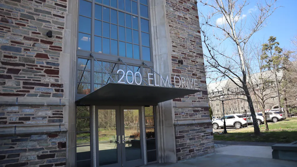 Brick building with large windows, addressed "200 Elm Drive" in silver lettering