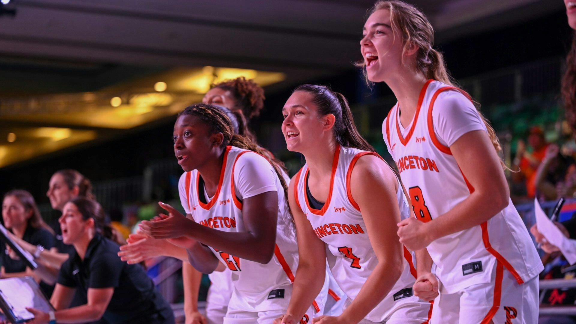 Basketball players celebrating on bench.