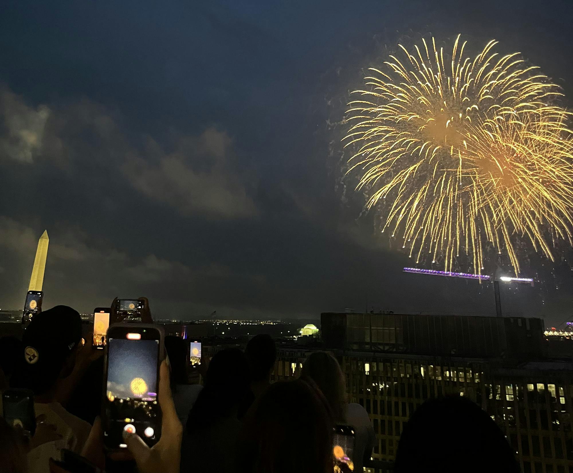View of fireworks from on top of a roof.