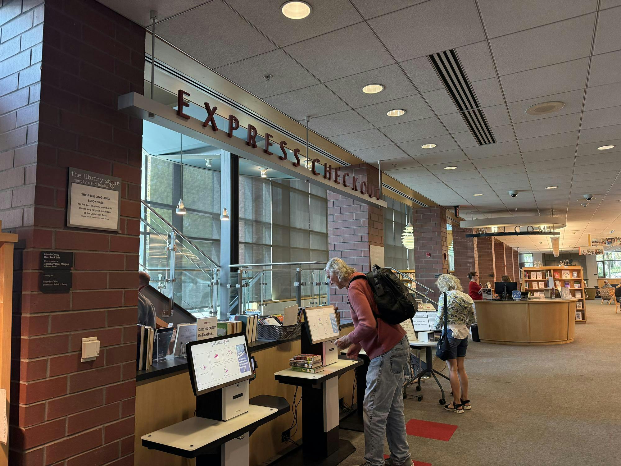 A man checks out a book at the self-check kiosk.