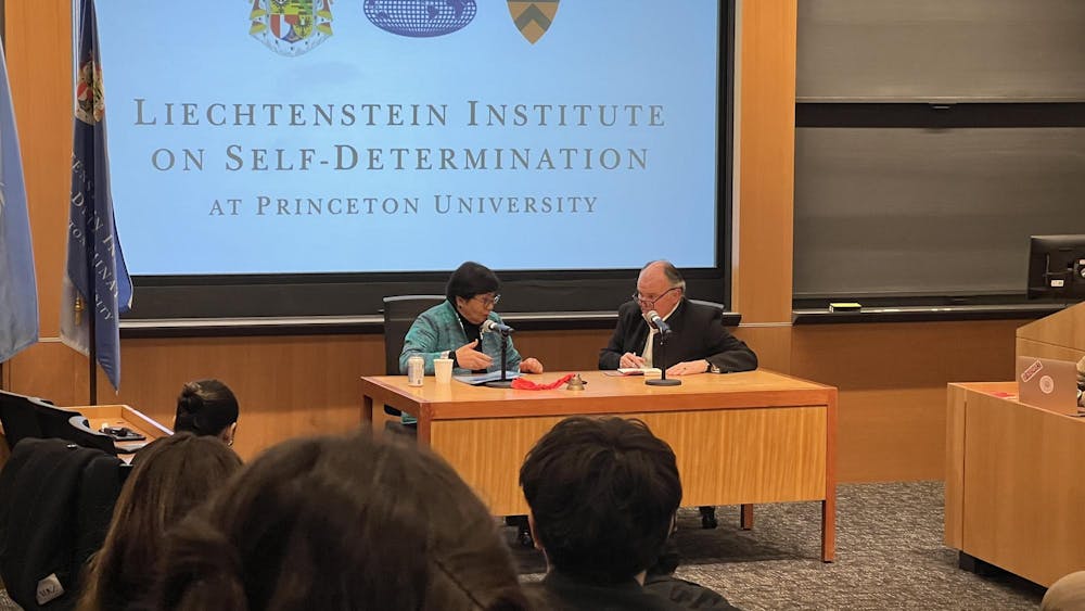 A speaker and a moderator in a room speaking to event attendees