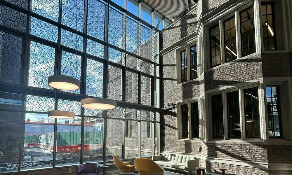 A brick building (Frist Health Center) with large windows, photo taken from the interior.