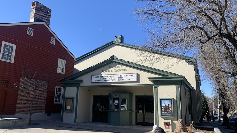Cream colored building with green trim. Green letters spell out “Princeton Garden Theatre.”