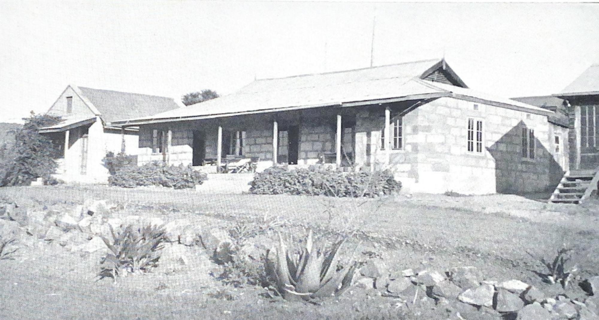 A black-and-white photo of the colonial-style ranch house.