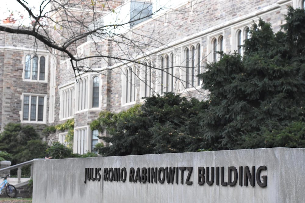 A sign reading Julis Romo Rabinowitz Building in the foreground of a gothic building.