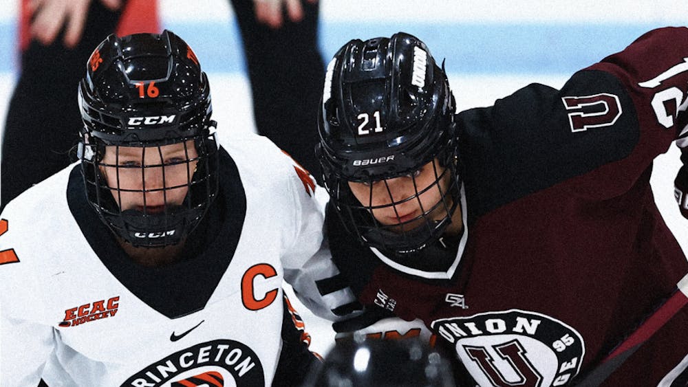 Princeton hockey player and Union hockey player stare downwards while next to each other